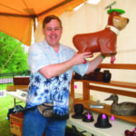 Stephen Meinhardt holds up a great little Yogi Bear ride-on toy, priced at $125.